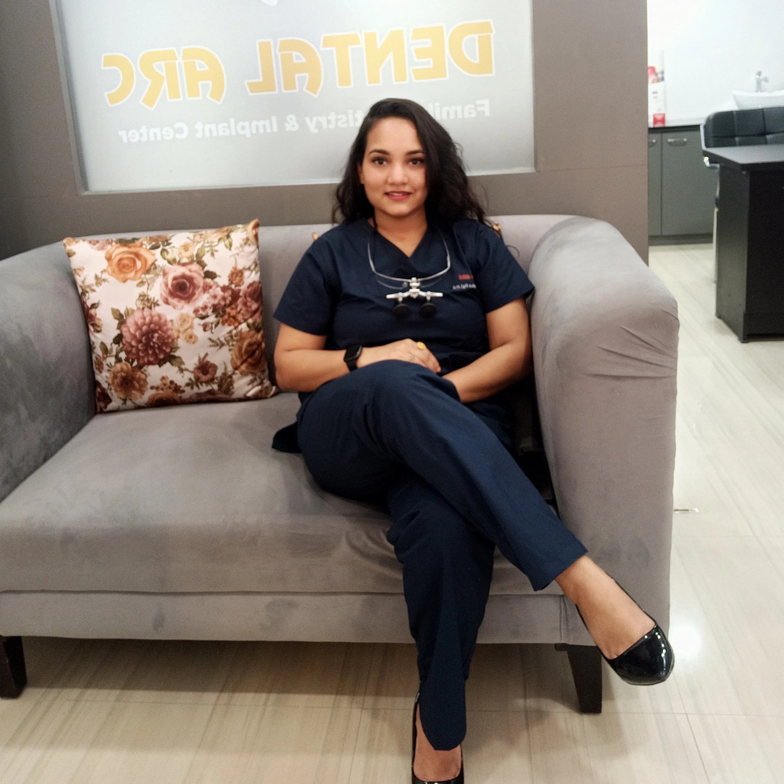 Dr. Archana Raj Jha seated inside the Dental Arc clinic